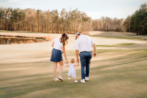Family Photographer, mom dad and son walking on golf course