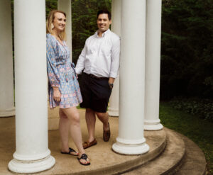 Family Photographer, couple leaning against pillars