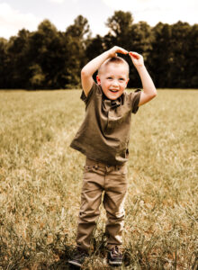 Family Photographer, boy standing in green grass