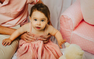 Family Photographer, father and child in pink dress with teddy bear