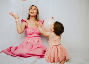 Family Photographer, mother and child in pink dress with balloons