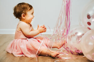 Family Photographer, child in pink dress with balloons
